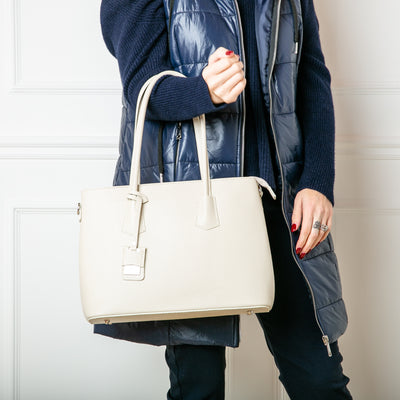The Richmond Leather Handbag in Cream being worn over one arm, made from 100% Italian leather