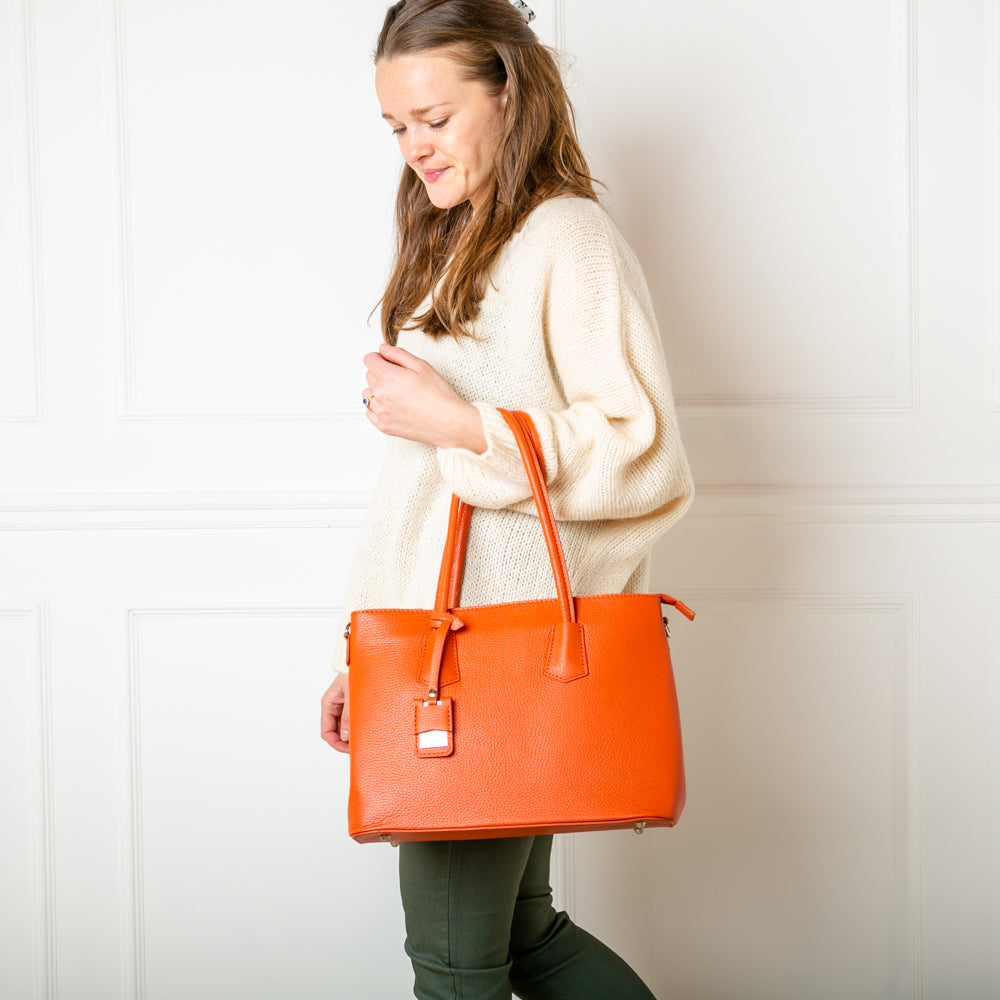 Our model wearing the versatile Richmond Leather Handbag in Orange paired with one of our Mohair V Neck Jumpers and Stretch Trousers