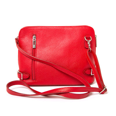 Sloane Handbag in red, shown from the front, including the adjustable leather strap, three side zip fastening, buckle detail and the outside pocket. Made from Italian leather.