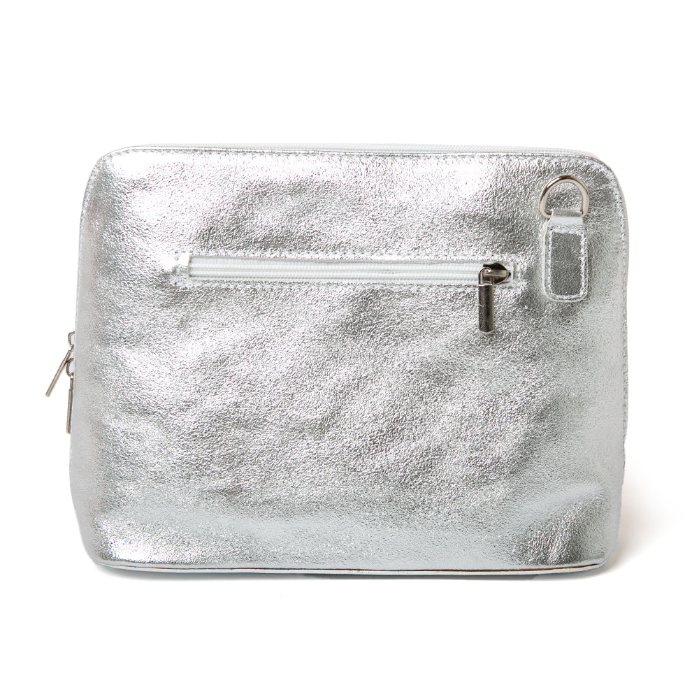 Italian leather Sloane Handbag in metallic silver, shown from the back, including the adjustable leather strap, three side zip fastening, buckle detail and the outside pocket. Reverse shot