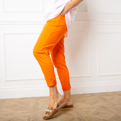 Stretch trousers in orange, elasticated women's trousers, pockets either side with cuffed ankles