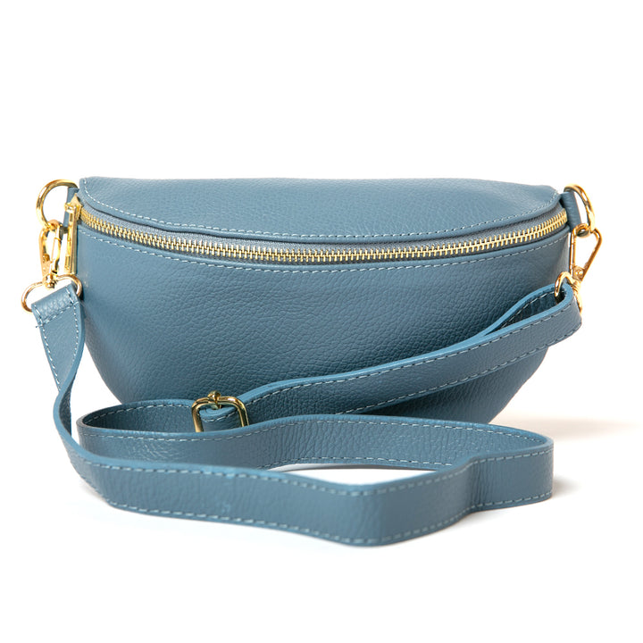 Winchester Leather handbag in Denim Blue, half moon shape, gold hardware, image showing the adjustable bag strap, easy to wear, soft Italian leather